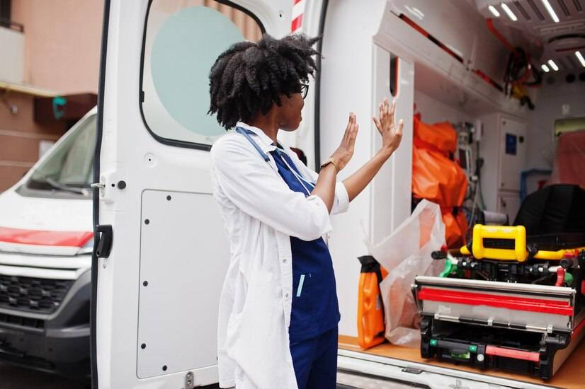 african-american-female-paramedic-standing-front-ambulance-car_627829-4907