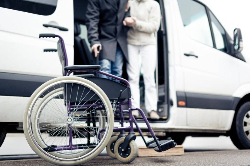 low-section-people-standing-vehicle-with-wheelchair-foreground_1048944-2001882